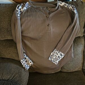 Size large. Brown with cheetah prints on shouldered and sleeve. New